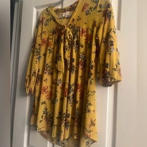 Cute shirt w/tie around neck. Shirt will look cute by itself or with a blazer.